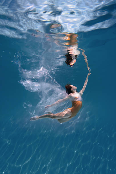 istock Athletic diver woman under water with plastic 1306365756