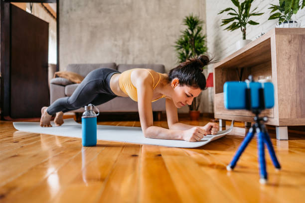istock Woman vlogger practicing yoga from home 1306365771
