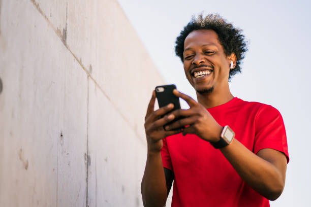 istock Athlete man using his mobile phone outdoors. 1306366098