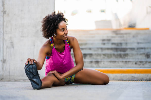 istock Afro athlete woman stretching legs before exercise. 1306366182
