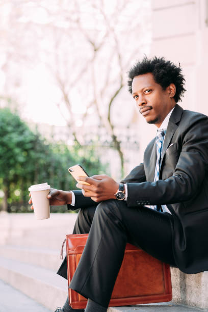 istock Businessman using his mobile phone outdoors. 1306366943