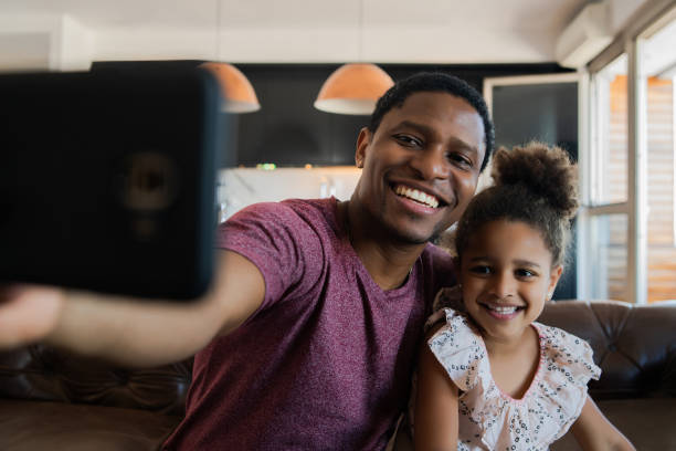 istock Daughter and father taking a selfie with phone. 1306367049