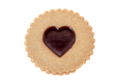 A strawberry jam shaped heart on a shortbread biscuit - white background