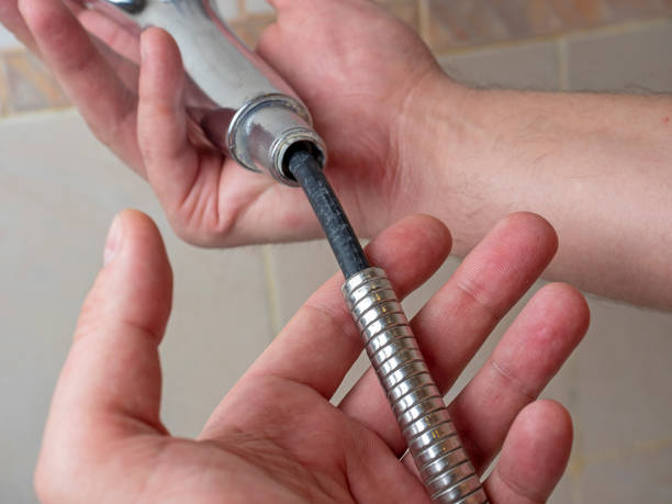 istock Broken chrome shower hose in men's hands. Rift, rubber, selective focus, shower equipment 1306367221