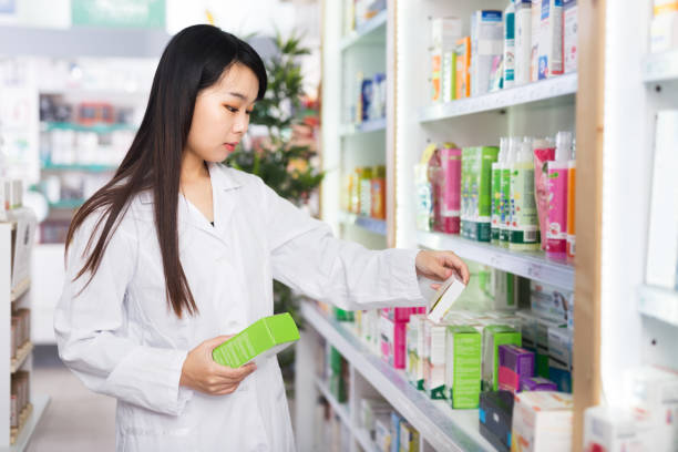 istock Chinese female pharmacist standing in pharmacy 1306368780