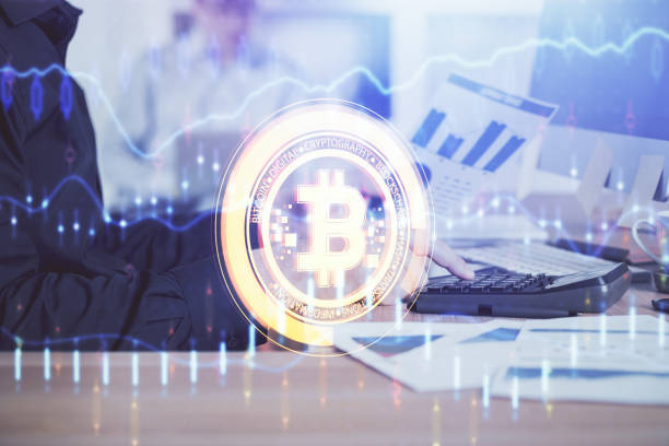 istock Crypto currency theme hologram with businessman working on computer on background. Concept of blockchain. Multi exposure. 1306370134