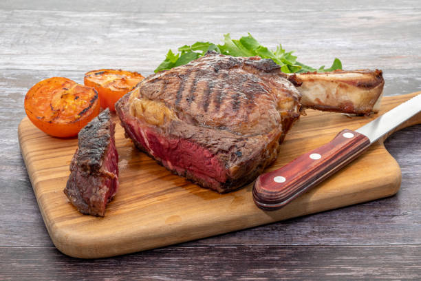 Grilled rib eye tomahawk steak cooked rare