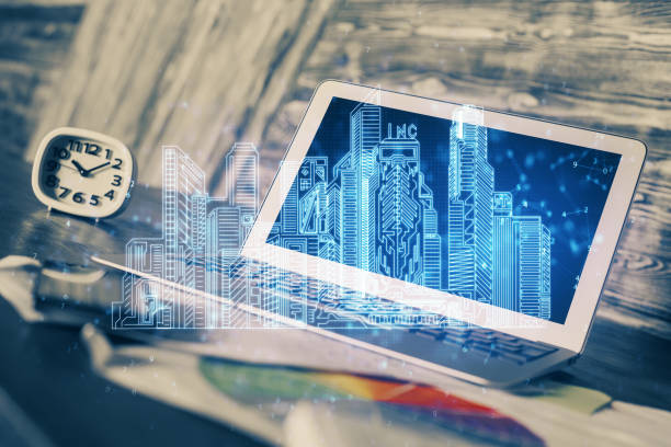 istock Desktop computer background in office and big town buildings hologram drawing. Double exposure. Smart city concept. 1306370443