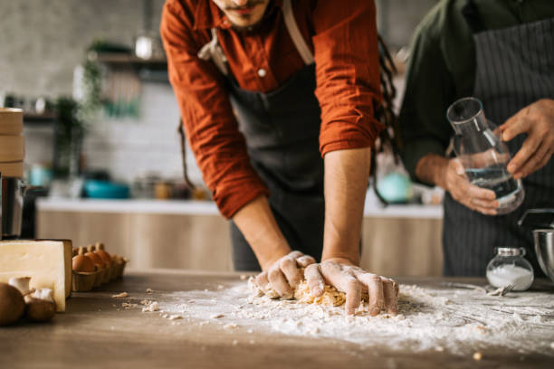 istock Senior father helping to his adult son in kitchen 1306372014