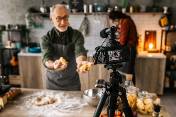 istock Senior vlogger broadcasting live cooking video online 1306372067