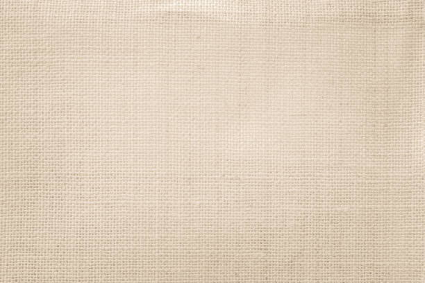 istock Jute hessian sackcloth canvas woven texture pattern background in light beige cream brown color blank empty 1306372098