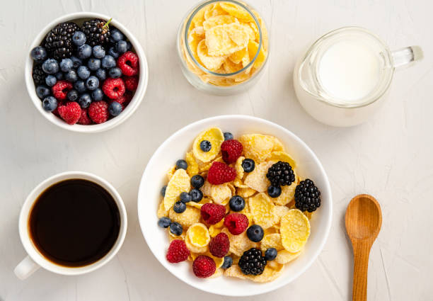 istock Cornflakes with milk and fresh berries on a white background. 1306372395
