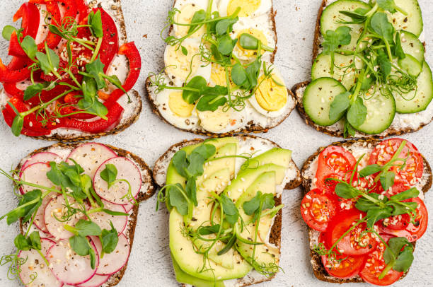 istock Different sandwiches with vegetables and microgreens on toast bread on a light background. 1306372535