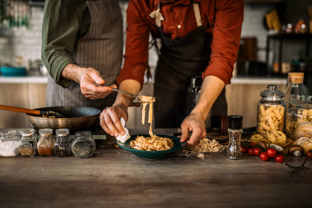 istock Young man learning cooking skills from an experienced chef. 1306372571