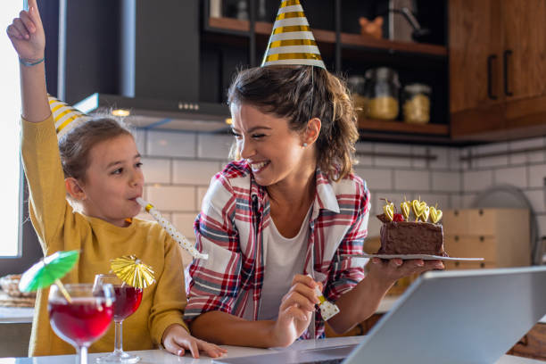 istock Mother and daughter at home, talking on a video call and having a celebration 1306372602