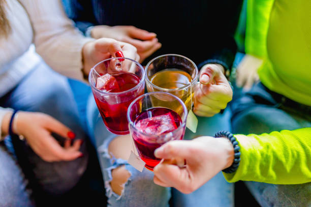 Hands of caucasian female friends toasting with tea cups