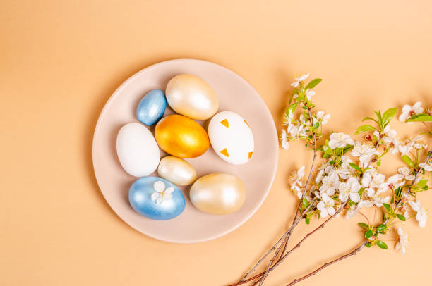 istock Easter nacreous eggs on a plate on a beige background with copy space. 1306372746