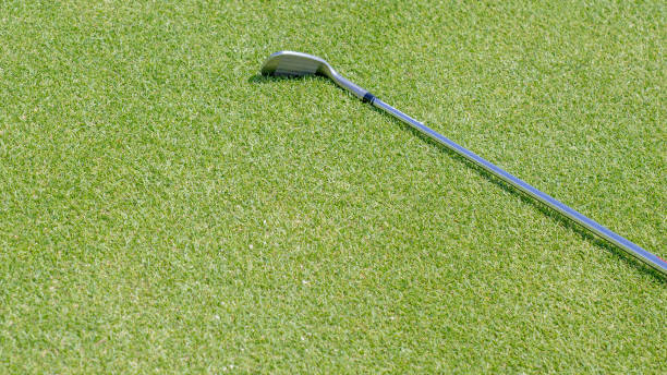 istock top view of iron golf club on the gold course grass. 1306373364