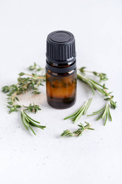 istock Rosemary and thyme sprigs with dark glass jar. 1306373471