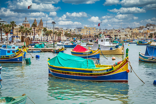 Marsaxlokk is a fishing village in the southeast of Malta known for its colorful boats called luzzu.