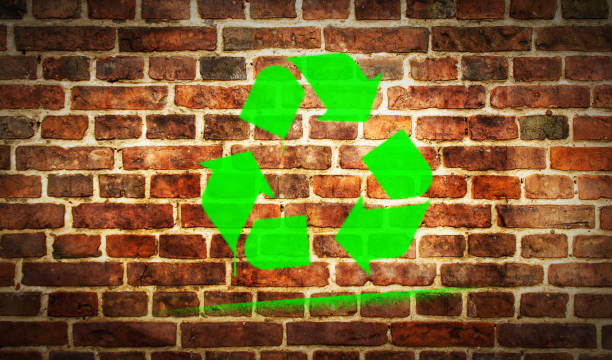istock Recycling green symbol spray painted on the brick wall 1306373512
