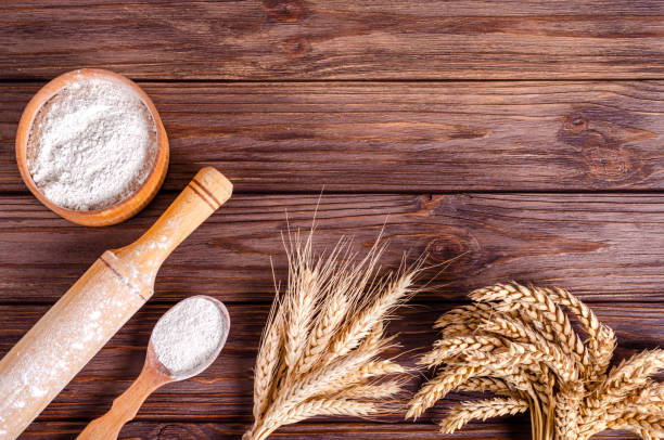 istock Spikelets of rye and wheat on a wooden background. 1306373714