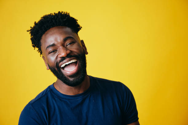 istock Playful Afro Man With Mouth Open Touching Ears 1306374068