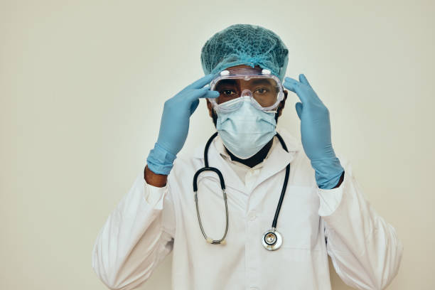 istock Male Doctor Adjusting Protective Eyewear 1306374142