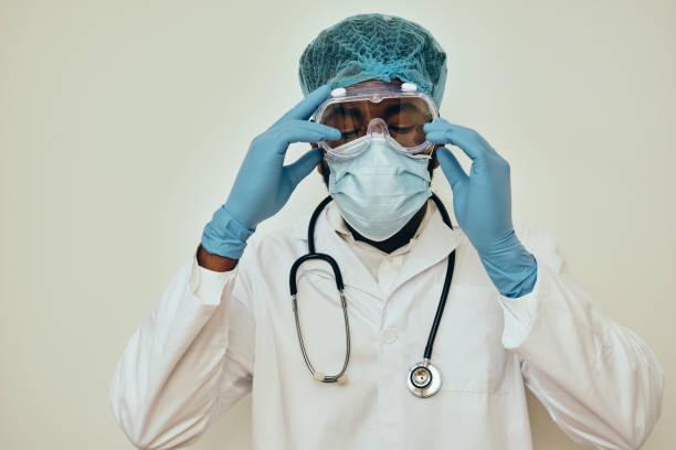 istock Male Doctor Adjusting Protective Eyewear 1306374145
