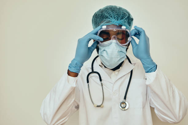 istock Male Doctor Adjusting Protective Eyewear 1306374146