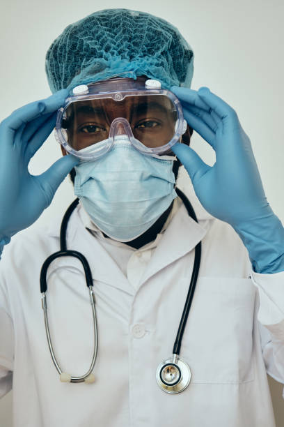 istock Male Doctor Adjusting Protective Eyewear 1306374149