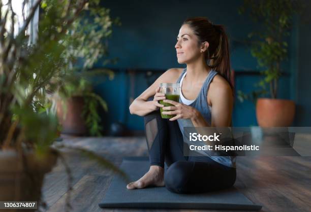 Fit Woman Drinking A Green Detox Smoothie At The Gym Stock Photo - Download Image Now