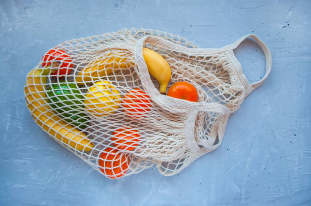 istock Eco bag with ripe fruits on grey background. 1306375020