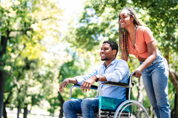 istock Man in a wheelchair enjoying a walk with his girlfriend. 1306376483