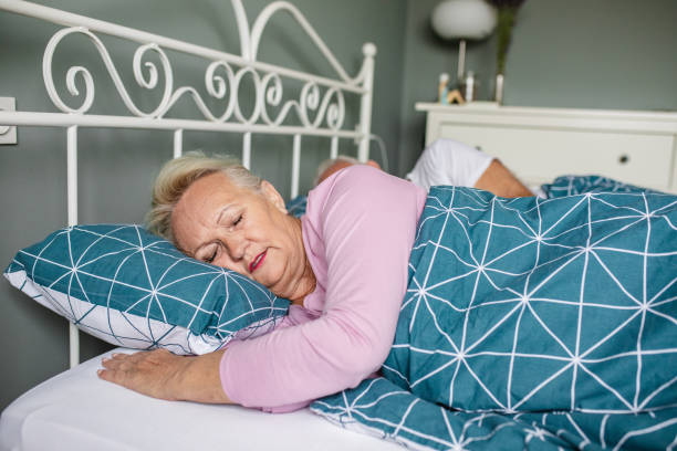 istock Senior couple sleeping together in bed 1306377535