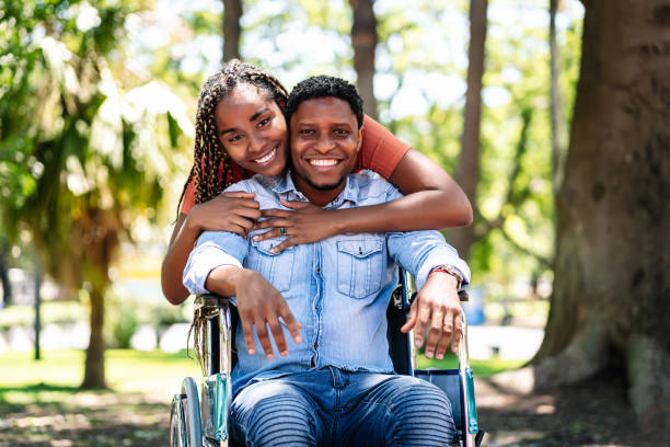 istock Man in a wheelchair enjoying a walk with his girlfriend. 1306377797
