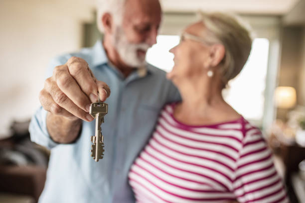 istock Senior couple with house key 1306378100