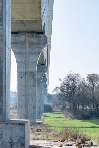 istock Bottom view of a modern aqueduct with its pillars. 1306379041