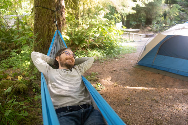 istock Smiling Caucasian Man Relaxing in Hammock in Washington State Park 1306379313