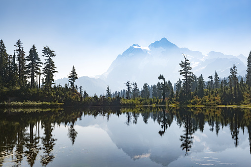 This is a hazy view of Mount Shuksan from Picture Lake in the North Cascades National Park in Washington on an autumn morning.