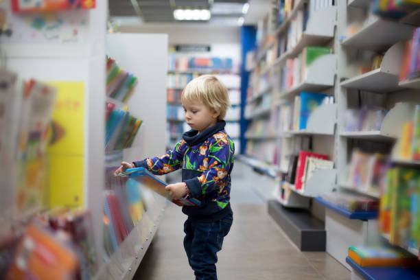 istock Adorable little boy, sitting in a book store 1306381133