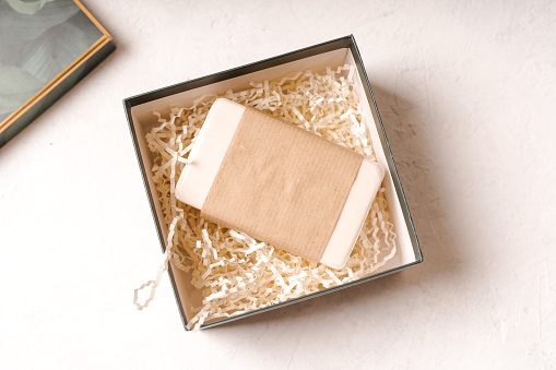 Soap in Craft eco Gift box or present box on white background with mockup blank paper package. Copy space for text and design. Zero waste, plastic free, eco friendly concept.