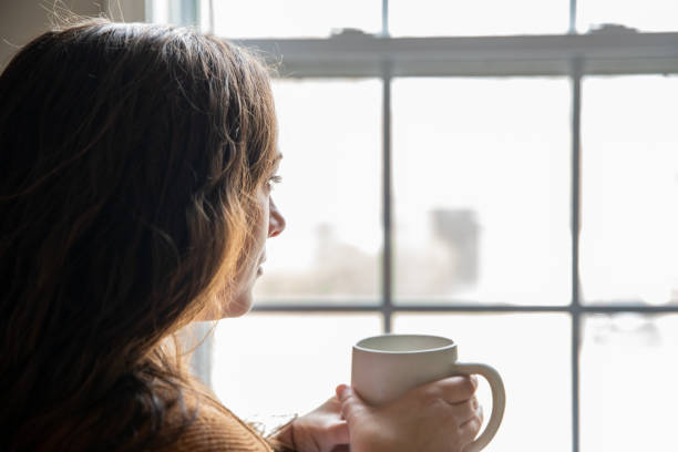 istock Mid adult woman deep in thought while working from home office 1306382470