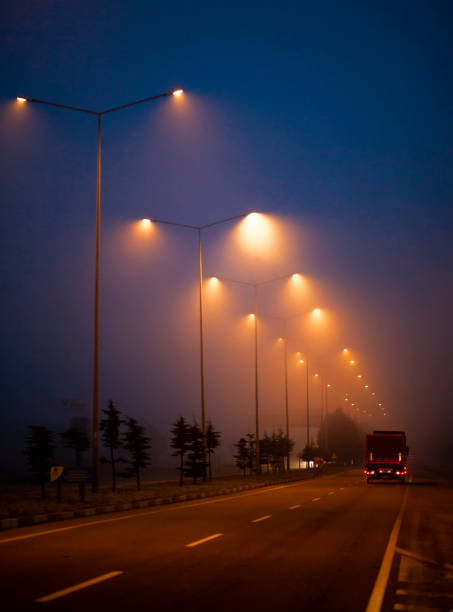 View of highway on foggy winter day.