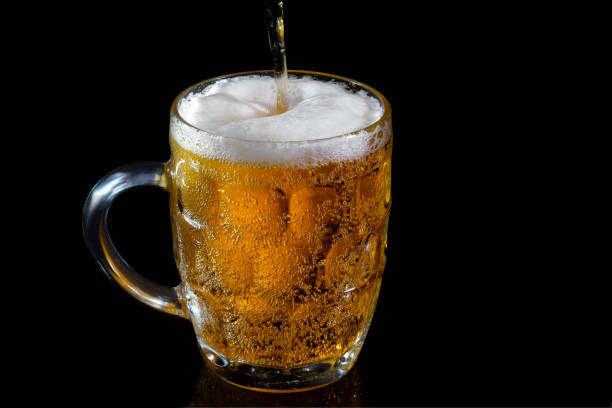 istock Light beer in a glass on a black background 1306384862