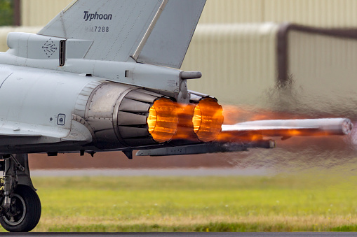 Gloucestershire, UK - July 14, 2014: Glowing hot afterburners of Italian Air Force Eurofighter Typhoon aircraft as it accelerates down the runway at RAF Fairford.