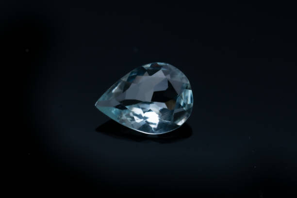 istock Natural stone blue topaz on a black background 1306385645