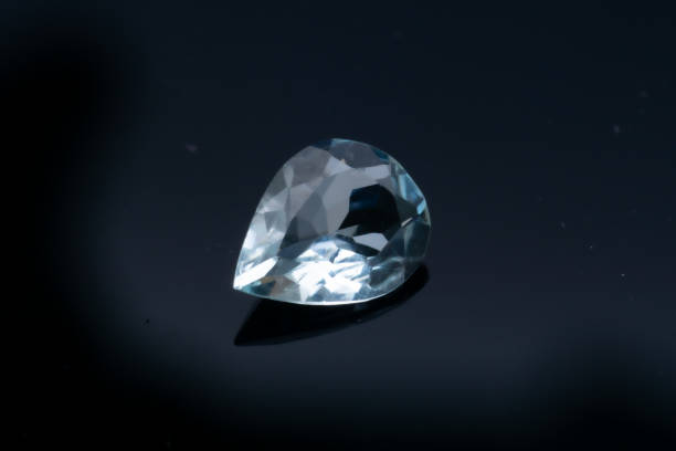 istock Natural stone blue topaz on a black background 1306385671