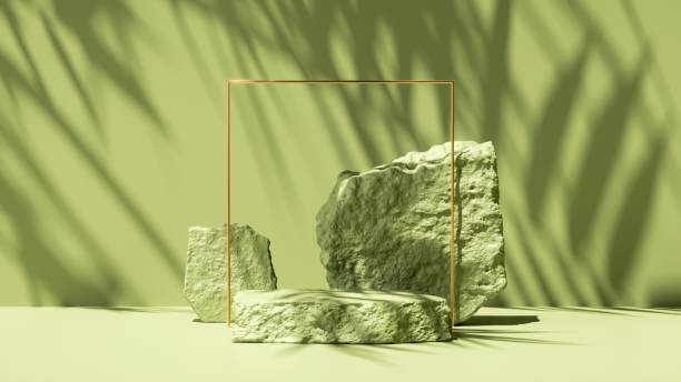 istock 3d render, abstract green background with tropical leaves shadow and bright sunlight. Minimal scene with cobblestone podium and golden square frame for cosmetic product presentation 1306388615