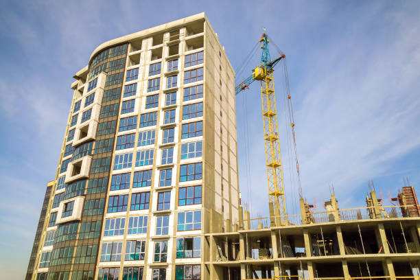 istock High residential apartment building under construction. Real estate development. 1306389495